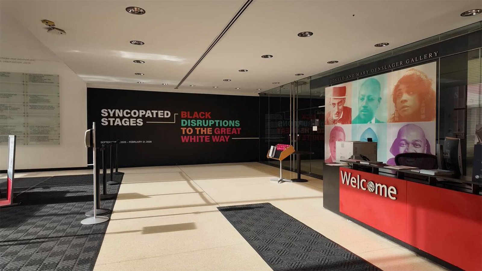 The plaza lobby of The New York Public Library for the Performing Arts. On the right, a red reception desk with 